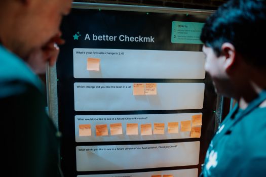 Road map contributions An Attendee contributing to the road map using stickers to vote on a pinboard